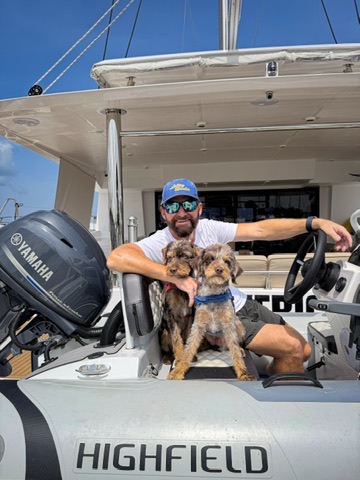 Bobby White with Cougar and Merlin aboard the tender